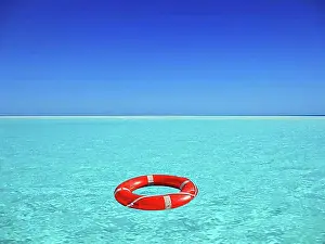 Drift Prints: Red lifebuoy floating on turquoise blue water in the sea, ocean, location unknown