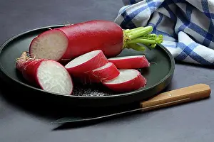 Knife Prints: Red radish (Raphanus), sliced on plate, food photography