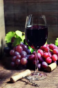 Luxury Prints: Red wine and red grapes on wooden background