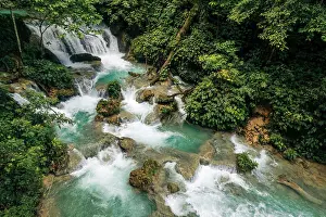 Refreshing Prints: Refreshing waterfall and cascades with lush vegetation at Air Terjun Laumarang in Indonesia; Bukit Mambual
