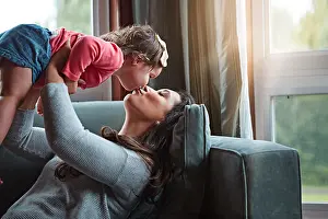 Quality Time Prints: Relax, happy and kiss with mother and baby on sofa for bonding
