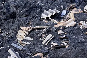 Accident Prints: The remains of burnt straw bales after a Farm barn fire with bits of asbestos roofing mixed with the straw