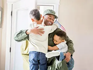 Apparel Prints: Returning soldier hugging children at door