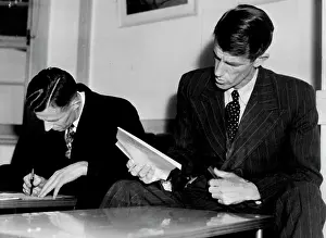 Forms Prints: Rex Hillary with his brother Sir Edmund Filling in the custom forms at Rose bay flying boat base this morning before