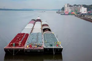 Trading Prints: A river barge passes by Alton, Illinois down the Mississippi River and under the Clark Bridge in Alton