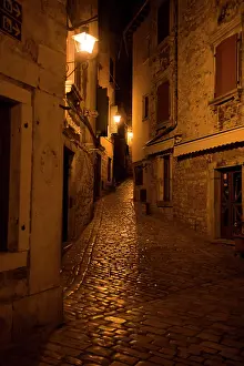 Luminous Prints: Romantic evening stroll through a charming cobblestone alleyway