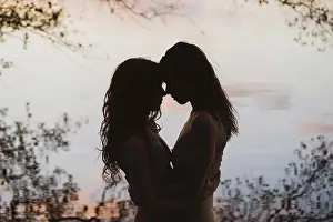 Nude Prints: romantic pastel coloured silhouette of lesbian queer couple by lake