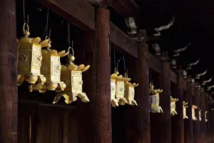 In A Row Prints: Row of golden japanese metal lanterns hanging in a temple, kyoto, japan