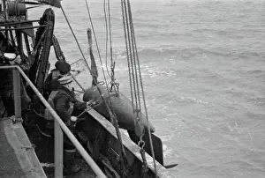 World War Prints: The Royal Navy during the Second World War The orepesa float on board a minesweeper being hoisted overboard