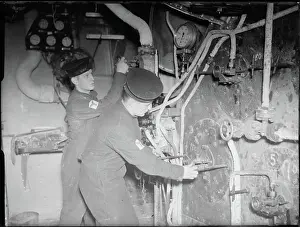 World War Prints: The Royal Navy during the Second World War A scene in the boiler room of a cruiser showing two stokers checking