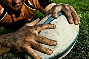 Grip Prints: Rugby player claiming the ball on a grassy field