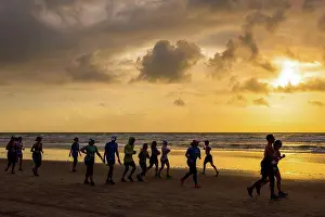 Runner Prints: Runners race on the beach at sunrise during the 2017 USA Beach Running Championships; Cocoa Beach