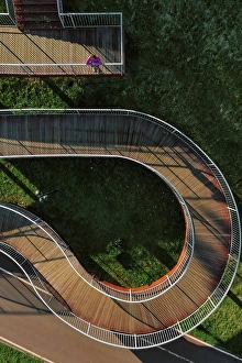 35 To 40 Years Prints: Russia, Aerial view of woman standing on winding boardwalk