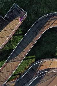 35 To 40 Years Prints: Russia, Aerial view of woman standing on winding boardwalk