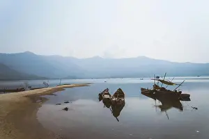 Waves Prints: Rustic boats on bay surrounded by mountains
