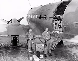 Midadult Men Prints: Saigon, Vietnam: 1966 Airmen loading ammunition into one of the three 7