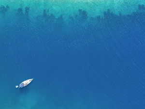 Sailboat Prints: A sail boat in bright blue Mediterranean waters near Skopelos