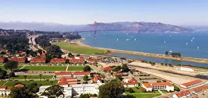 Francisco Prints: Sailboats fill the bay below the Golden Gate Bridge in the bay on the waterfront of San Francisco CA