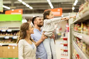 Father Prints: sale, shopping, consumerism and people concept - happy family with child buying food at grocery store or supermarket
