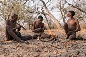 Tribe Prints: San Bushmen work together to make an arrow, eastern Namibia, Africa