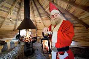 Holidays Prints: Santa Claus holding lamp in cot