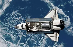 Logistics Prints: Satellite view of a space shuttle with earth in the background