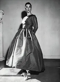 1950 Prints: Scarlet Nights -- A red faille evening gown with a close-fitting bodice covered by a bolero
