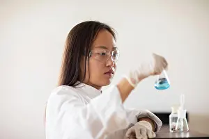 Technician Prints: scientist female with sample and tubes in a lab