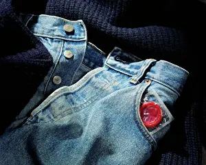 Sweater Prints: Sealed condom poking out of a jeans pant pocket