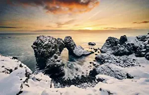 Seascape Prints: Seascape with snowy rocks and ocean during sundown