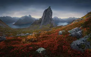Weather Prints: Segla mountain located in grassy valley near calm basin against dark overcast sky on island of Senja