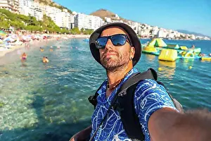 Visitor Prints: Selfie of tourist on vacation sitting by the sea at Saranda Beach on the Albanian Riviera in Sarande