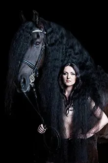 Looks Into The Camera Prints: Semi-nude, young woman and black horse, Friesian, gelding, Austria, Europe