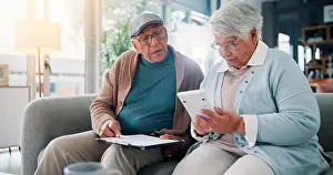 Problem Solving Prints: Senior couple, calculator and documents on couch with finance