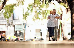 Baby Boomer Prints: Senior couple dancing together in the street