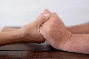 Grownups Prints: Senior couple holding hands on table
