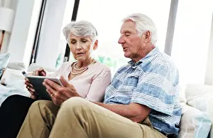 Invest Prints: Senior couple, house and tablet with credit card on sofa for online shopping