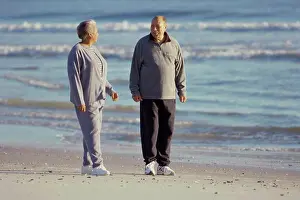 Bald Prints: Senior couple standing on the beach
