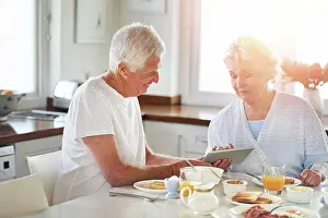 Video Prints: Senior couple, tablet and eating food in kitchen on social media