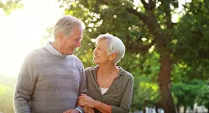 Bokeh Prints: Senior couple, walking and happy outdoor at a park with love