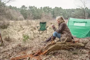 Ten T Prints: Senior lady sitting enjoying the wilderness from her campsite