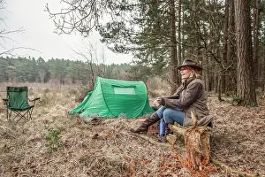 Ten T Prints: Senior lady sitting enjoying the wilderness from her campsite