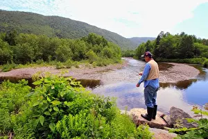 Baseball Cap Prints: Senior man fly-fishing in a stream