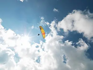 Amuse Prints: Senior paraglider in midair against sky