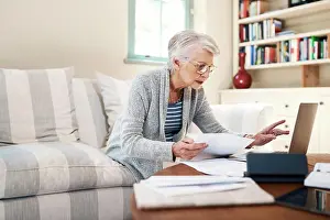 Paperwork Prints: Senior woman, paperwork and laptop for insurance in home