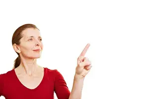 Elderly Prints: Senior woman pointing with her index finger to invisible touchscreen