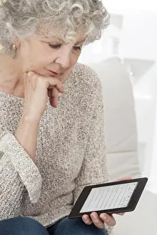 70 100 Years Prints: Senior woman reading an ebook