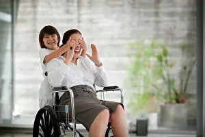 Handicapped Prints: Senior woman in a wheelchair, receiving a visit from her grandson