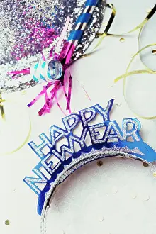 Letter Prints: Sequined hat with a Happy New Year sign and streamers