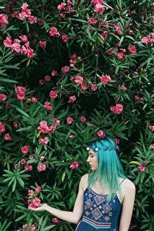 Serene People Prints: Serene young woman with blue hair standing below flowering tree